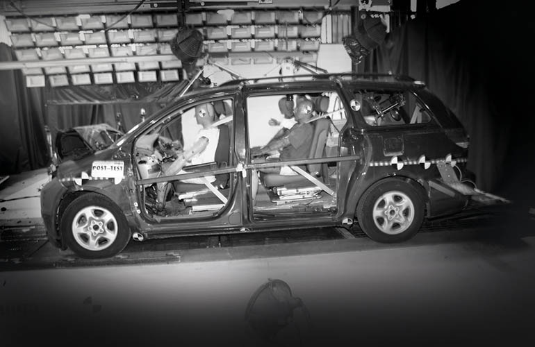 Car with crash test dummies inside during a crash test