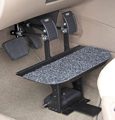 The pedals of a car adapted with extensions. 