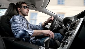 Man driving a car with hand controls