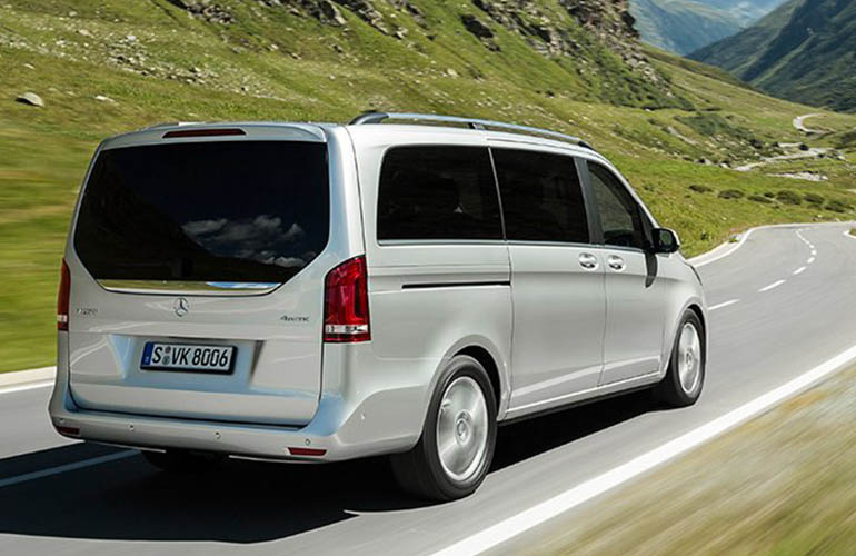 Grey Mercedes Benz van driving in the mountains