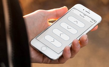 Hand holding a smartphone with the Braunability remote app open