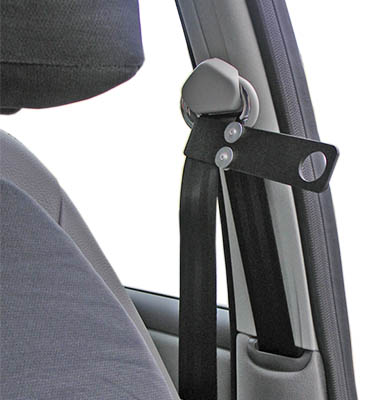 A seat belt inside a car with a small grip attached to it. 