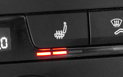 Close up of a vehicle’s seat heat button. 