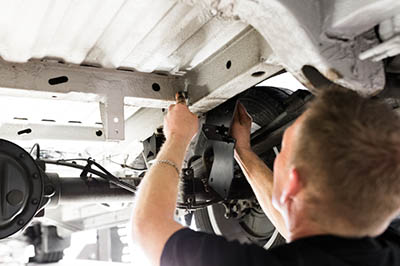 A person working under a vehicle. 