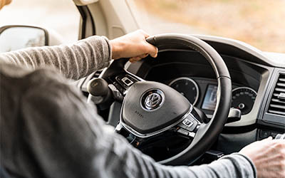 Hands on a steering wheel. 