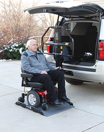 Man boarding a Joey Lift with his electric wheelchair