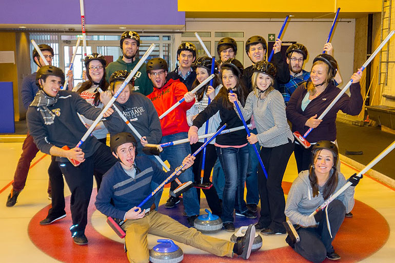 Carthage College students posing in Curling gear