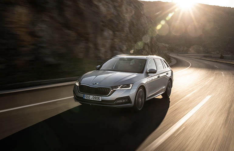 Grey Renault Talisman driving on a road by the water