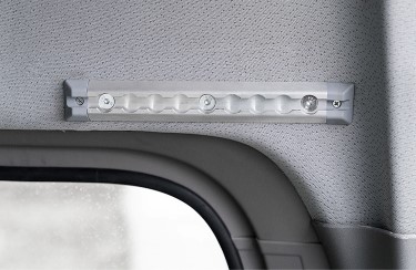 A short piece of rail over the window of a van. 