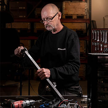 Technician measuring a piece of metal