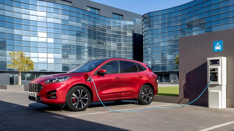 A red electric car charging.