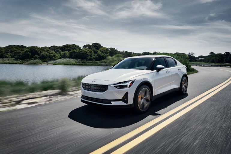 A white electric car on the road.