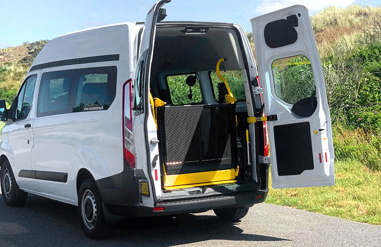 E-Series folding platform wheelchair lift in a Ford Transit.