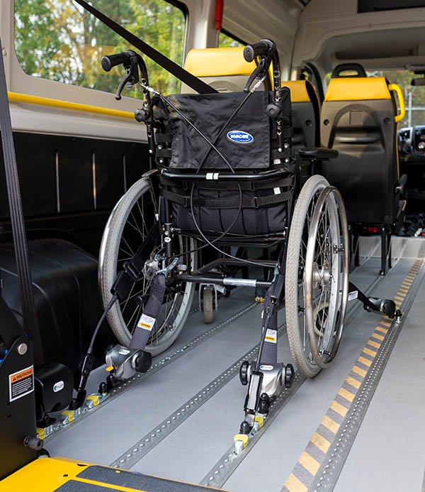 Weehlchair secured inside a vehicle by tie-downs