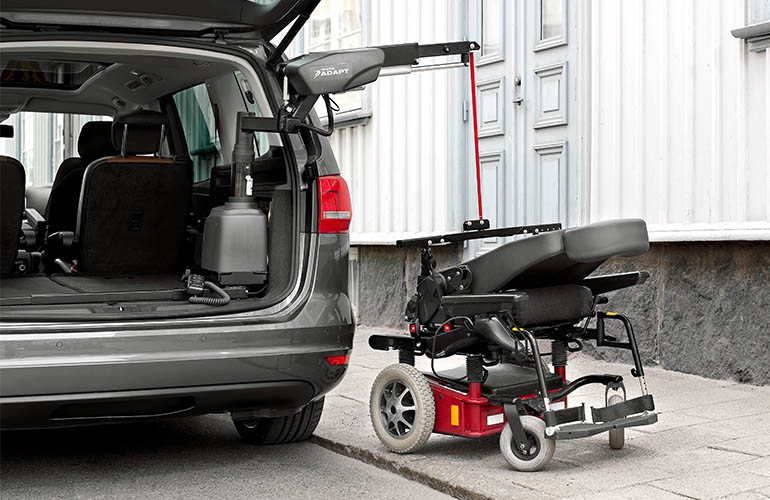 A powered wheelchair being lifted into a car with a Carolift 6900